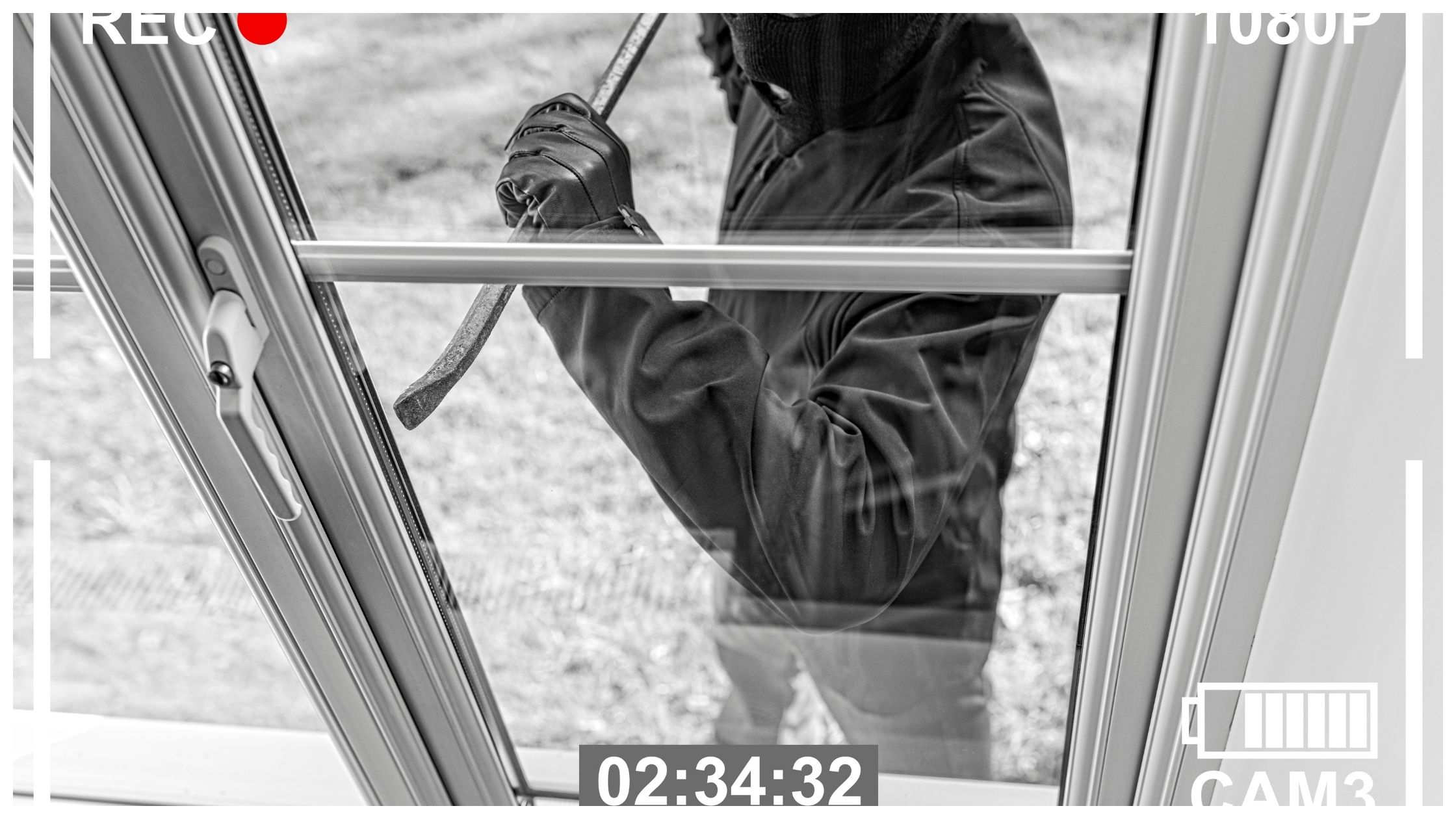 CCTV view of burglar breaking in to home through window