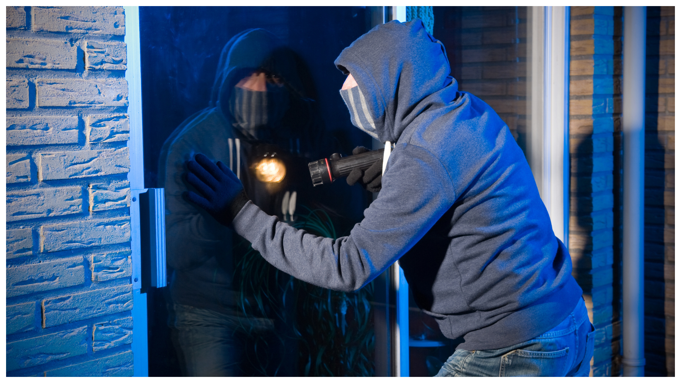 A burglar trying to forcefully enter a house